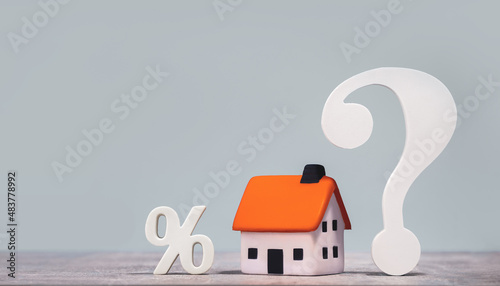 mortgage calculator or real estate business concept. Office desk with a white and wooden houses. timber costs copy space banner. Loan or insurance rate payments guidance support. Liability and risk photo