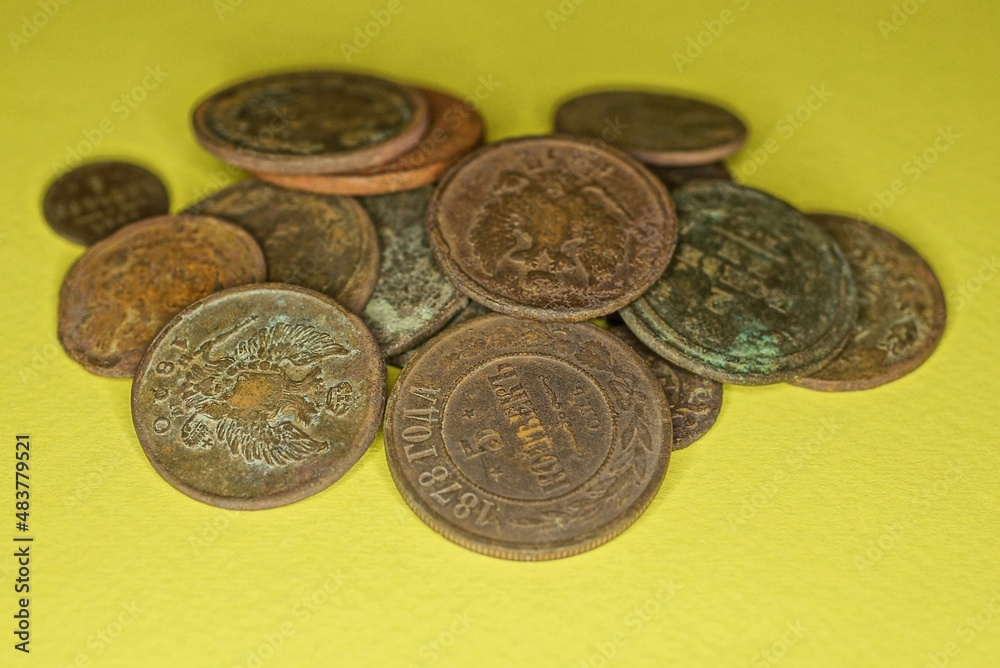 heap of old rarity copper coins lie on a yellow table heap of old rarity copper coins lie on a yellow table
