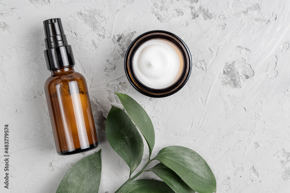 Set of natural cosmetic products in dark glass bottle and jar. Organic moisturizer cream and lotion. Skincare, beauty treatment concept. Set of natural cosmetic products in dark glass bottle and jar. Organic moisturizer cream and lotion. Skincare, beauty treatment concept.