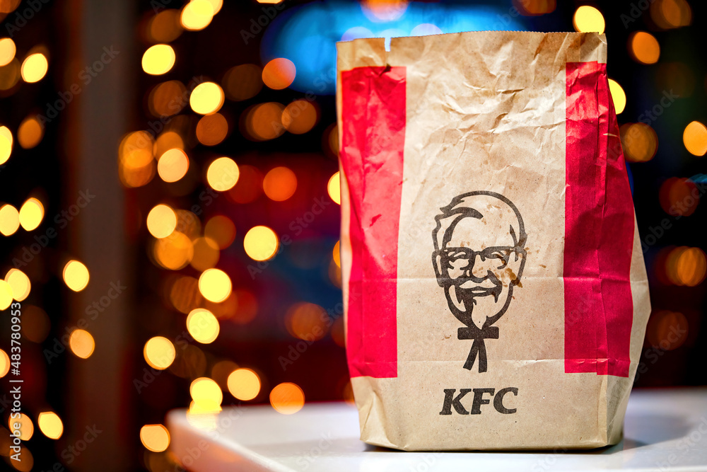 Minsk, Belarus. Jan 2022. KFC Paper bag on glowing garland background