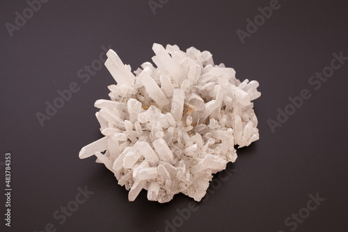 A clear quartz cluster against a black background