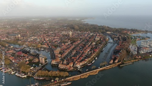 Aerial view on the historic town Enkhuizen in the Netherlands, situated on the edge of the IJsselmeer lake with historic buildings, towers and churches photo