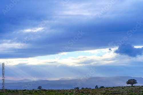 Golan Heights landscape, and sunbeams, on a cloudy winter day photo