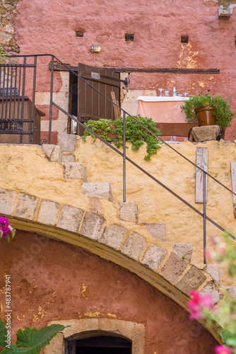 Traditional restaurant building facade, terrace with wc doors, table and stairs in old town of Chania, Crete, Greece