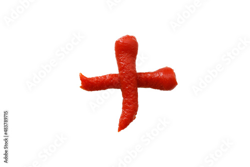 tomato ketchup in the shape of a plus sign isolated on white background