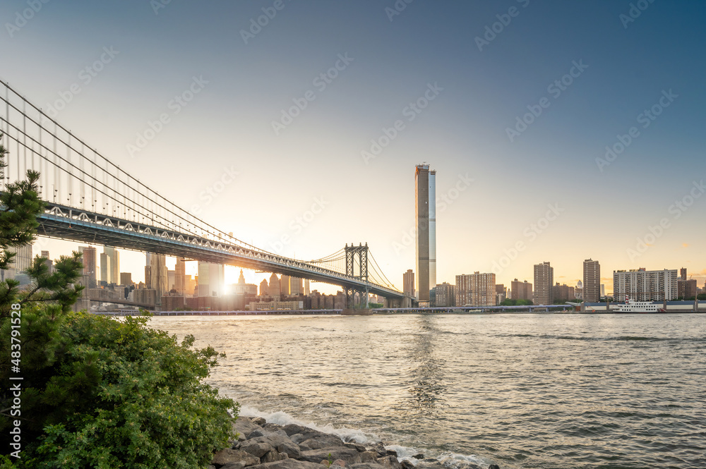 View of Manhattan Bridge and East River at sunset - Manhattan, NYC, USA View of Manhattan Bridge and East River at sunset - Manhattan, NYC, USA