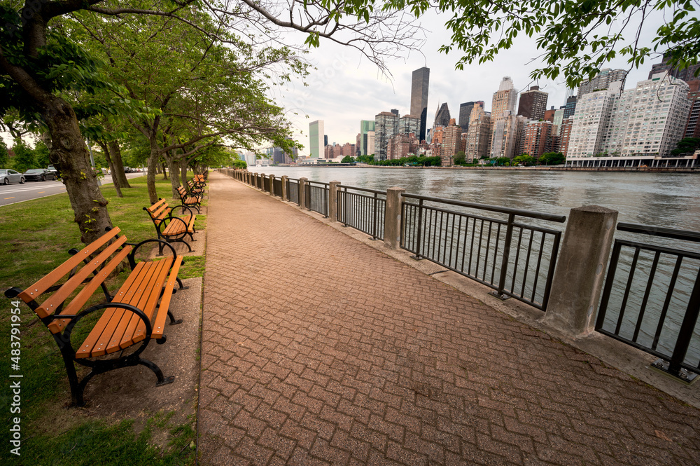 park benches in park with view of Manhattan  - River walk, Roosevelt Island, New York, USA