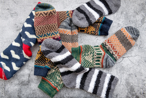 A pile of warm Winter socks in a grey concrete background.