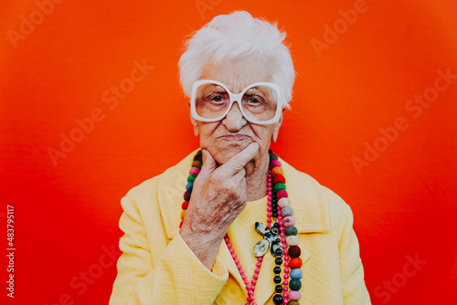 Funny grandmother portraits. Senior old woman dressing elegant for a special event. granny fashion model on colored backgrounds photo