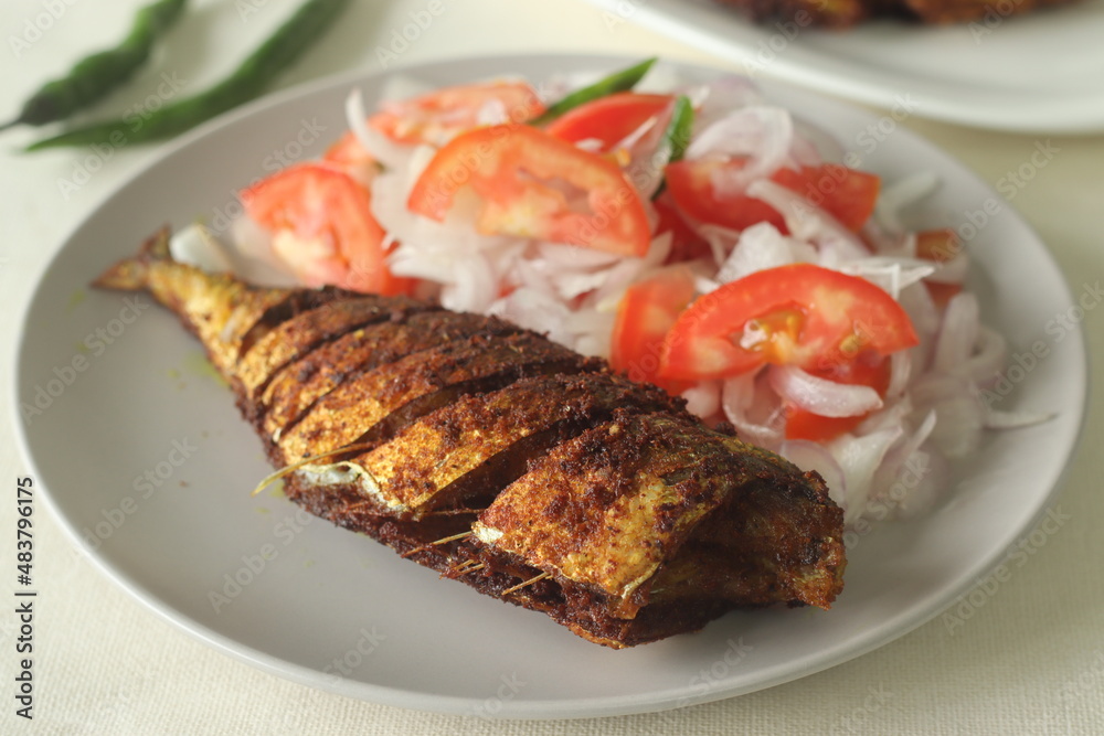 Ayala Meen fry or Mackerel fish fry. Spicy fish fry prepared in South Indian style. Mackerel fish marinated in an oil marinade and shallow fried in oil, served with onions