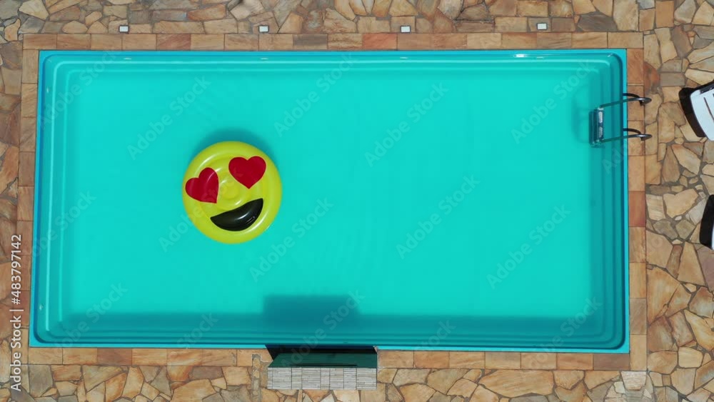 Top view of smile emoji float at swimming pool. Float smile emoji