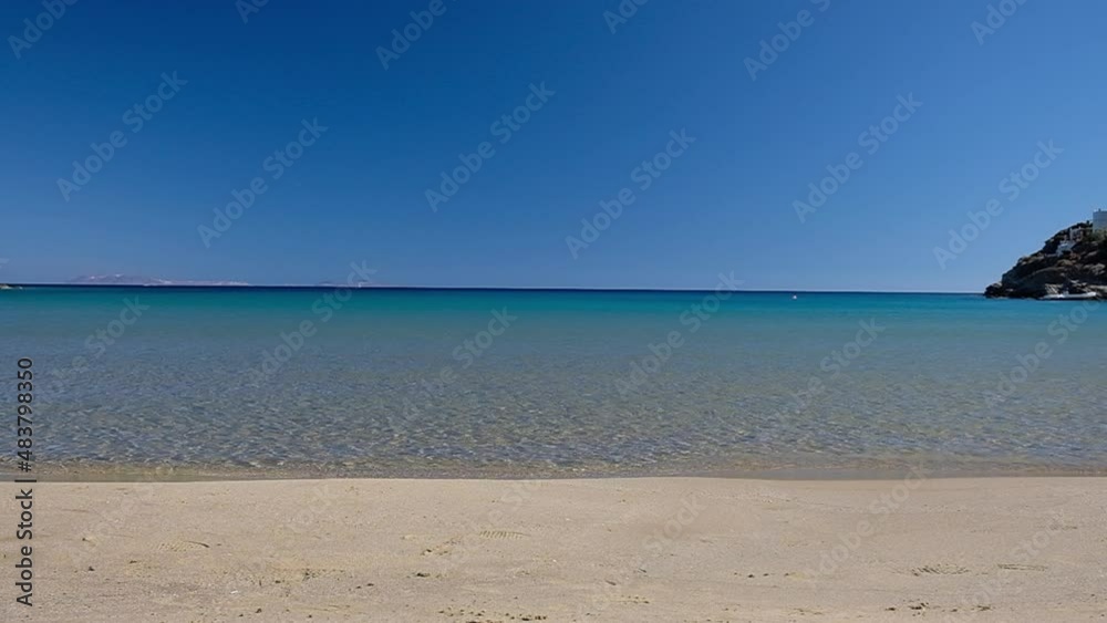 The paradisiac sandy and turquoise beach of Plakes in Ios Greece in slow motion The paradisiac sandy and turquoise beach of Plakes in Ios Greece in slow motion