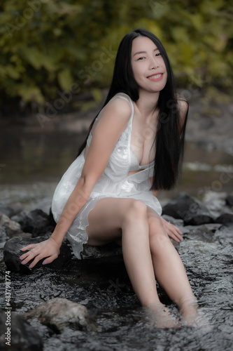 Portrait of sexy asian woman at the waterfall,Feeling fresh at the river,Thai female relax at country