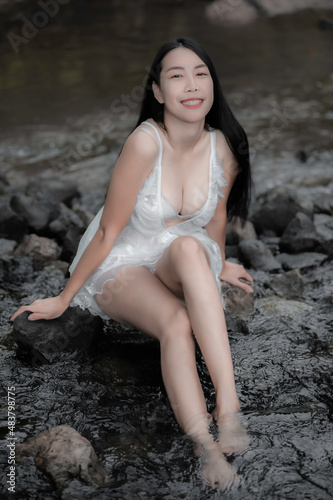 Portrait of sexy asian woman at the waterfall Feeling fresh at the river Thai female relax at country