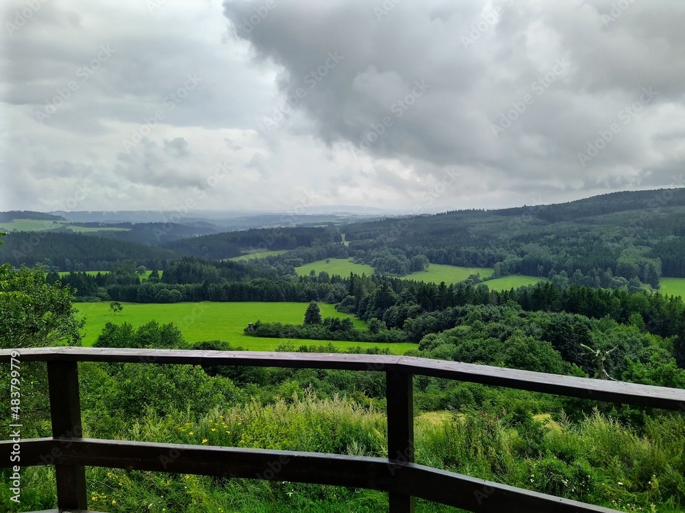 Dramatic scenery captured right before a heavy rain in a beautiful nature of Czech republic. A colorful view of the astonishing green colour of the forest and meadow.