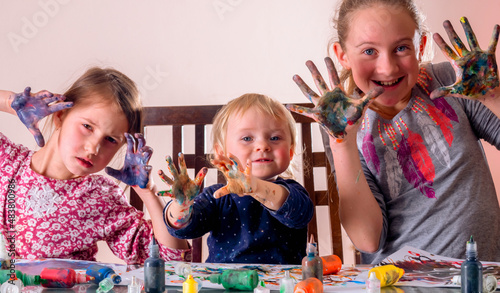 Wallpaper Mural Happy little children with funny facial expressions and painted hands drawing and having fun. Concept: carefree happy childhood, learning art and creativity. Torontodigital.ca