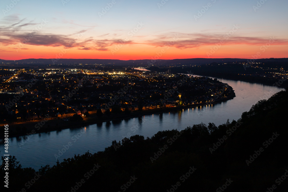 Koblenz am Rhein after sunset. The city lights are on.