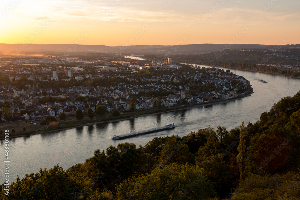Koblenz am Rhein at sunset. A ship sails on the river.
