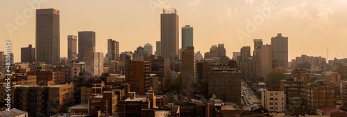 A horizontal panoramic cityscape taken at sunset, of the central business district of the city of Johannesburg, South Africa photo