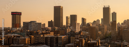 A horizontal panoramic cityscape taken at sunset, of the central business district of the city of Johannesburg, South Africa