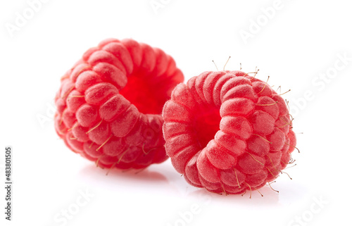 Two raspberries in closeup on white background