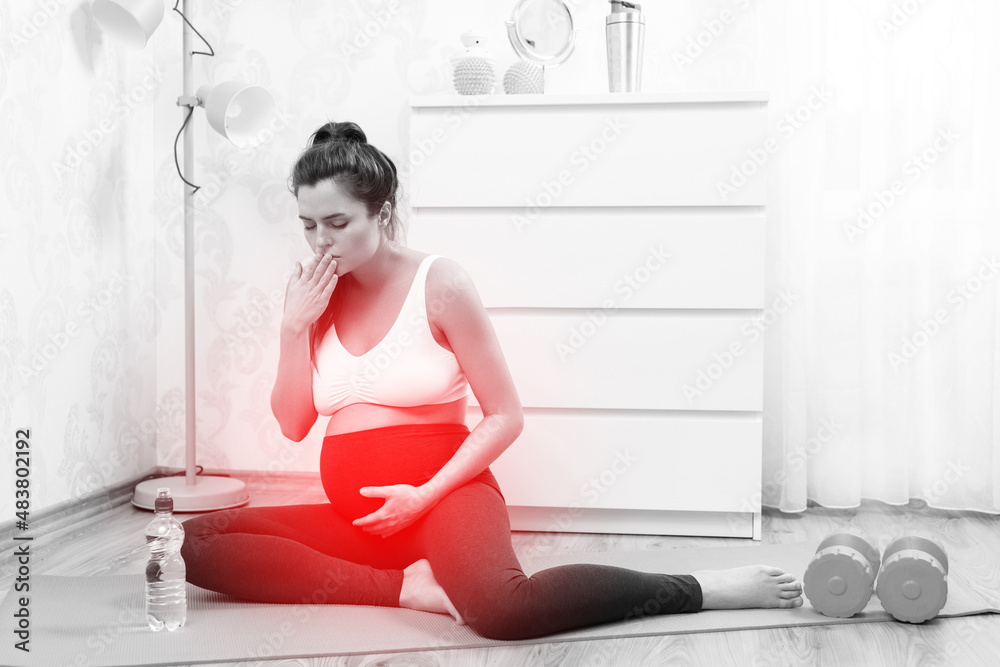 Pregnant woman feel bad during her fitness workout at home Pregnant woman feel bad during her fitness workout at home