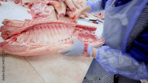 DONETSK, UKRAINE-DECEMBER 15,2018-Food industry, meat processing. Butchers cut pork at the meat processing plant in the cutting shop.
