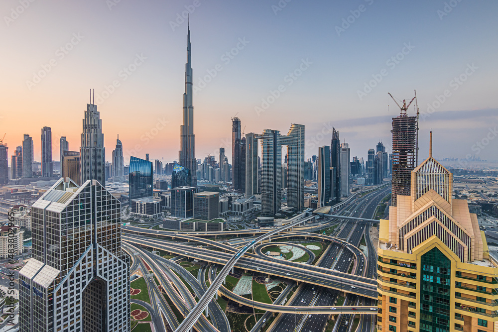 Skyline in Dubai Downtown at sunrise. High rise buildings with major intersection of sheik zayed road. Tallest building in the city of Dubai Burj Khalifa with skyscapers
