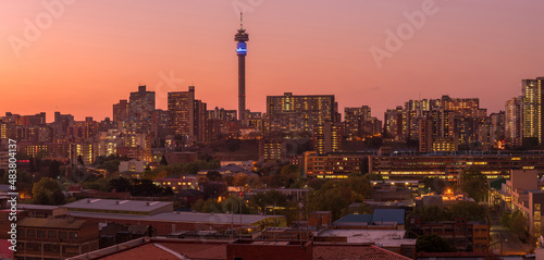 A horizontal panoramic cityscape taken after sunset, of the central business district of the city of Johannesburg, South Africa photo