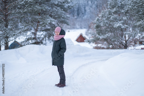A woman in the countryside in a snowy winter.