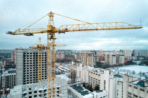 Construction crane on the background of the construction site.