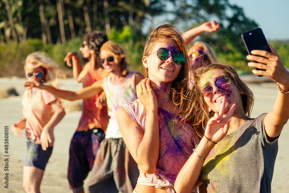 happy people taking self portraits on smartphone in India Goa fest