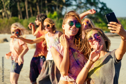 happy people taking self portraits on smartphone in India Goa fest