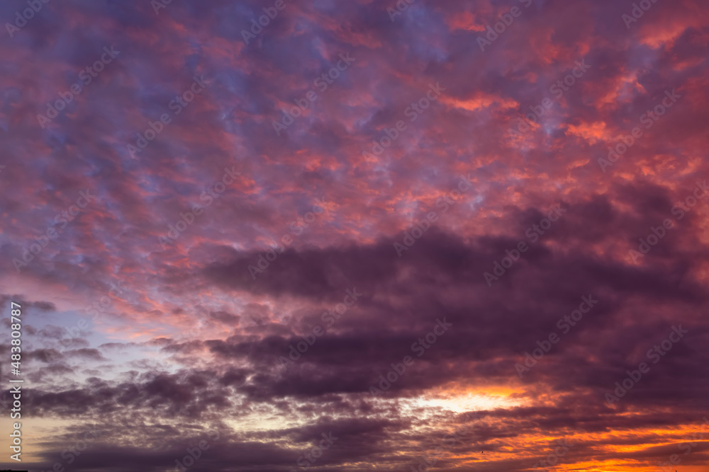 A colorful dusk sky with red and pink colors as background or texture