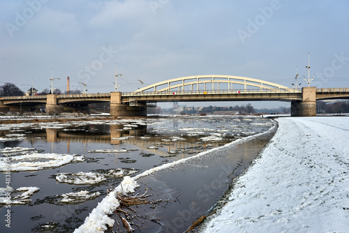 Floe on the Warta River and a road bridge during winter in the city of Poznan