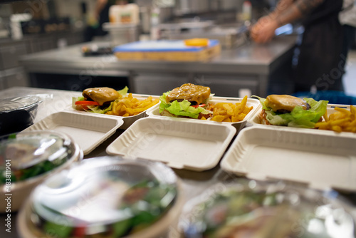 Meals in containers prepared for take away in kitchen restaurant.