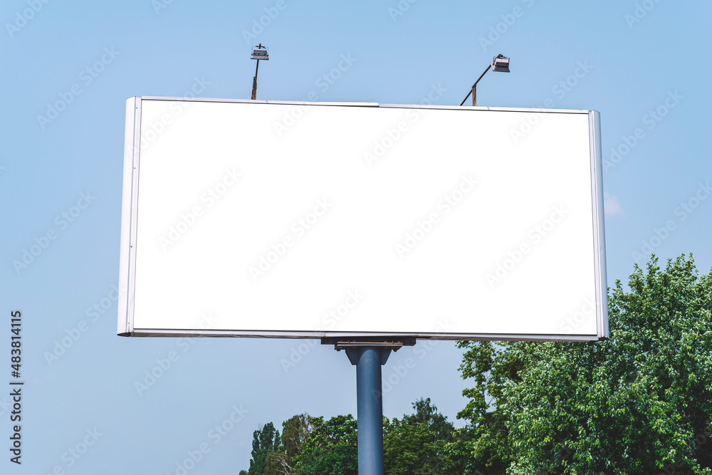 Blank billboard mockup with white screen. Against the backdrop of nature and blue sky. Business concept. Copy space banner for advertising. Blank billboard mockup with white screen. Against the backdrop of nature and blue sky. Business concept. Copy space banner for advertising.