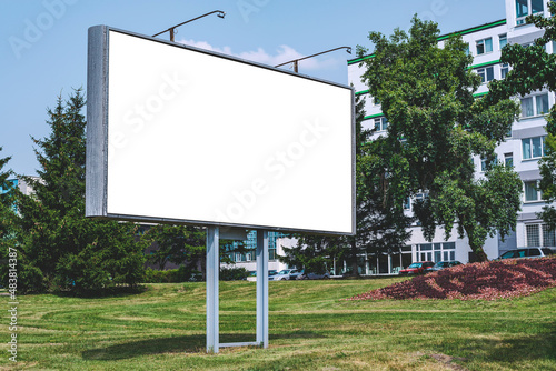 Blank billboard mockup with white screen. Against the backdrop of nature and blue sky. Business concept. Copy space banner for advertising.