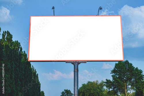 Blank billboard mockup with white screen. Against the backdrop of nature and blue sky. Business concept. Copy space banner for advertising.