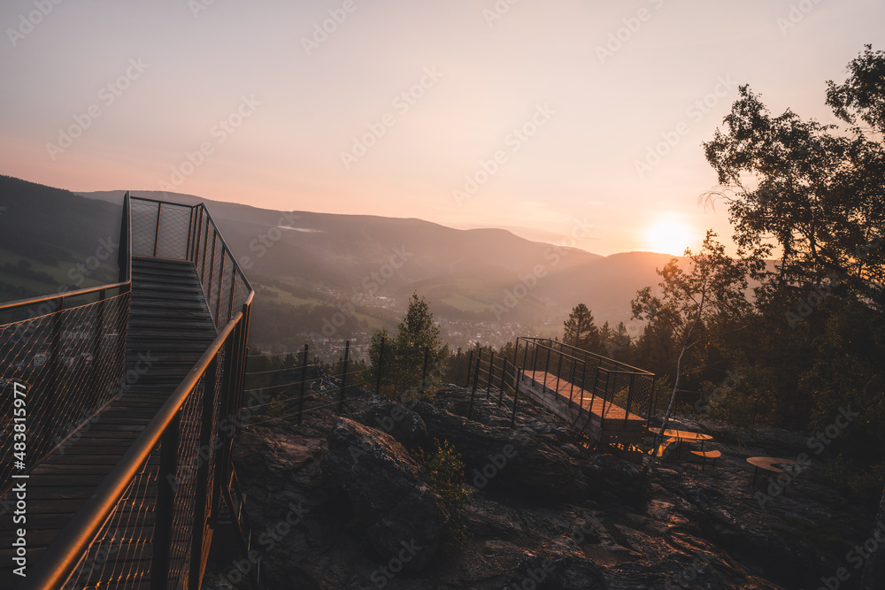 Man standing on a new and modern lookout forest park The Guard Patrol, Czech: Straz, while watching sunrise, Sunrise on Straznik Hill above Rokytnice nad Jizerou, Giant Mountains National Park Man standing on a new and modern lookout forest park The Guard Patrol, Czech: Straz, while watching sunrise, Sunrise on Straznik Hill above Rokytnice nad Jizerou, Giant Mountains National Park