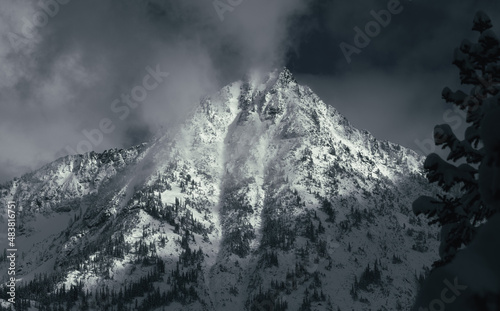 Panorama of dramatic snowy peaks above the clouds in the North Cascades, Washington
