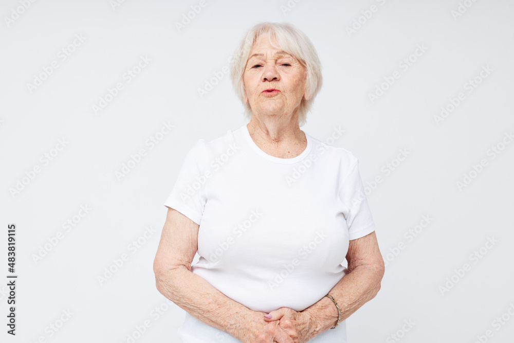 emotional elderly woman in a white t-shirt cropped view emotional elderly woman in a white t-shirt cropped view