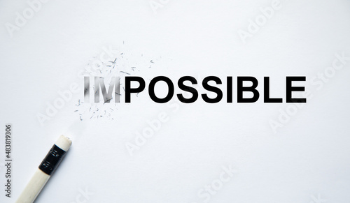 Changing the word impossible to possible with a pencil eraser photo
