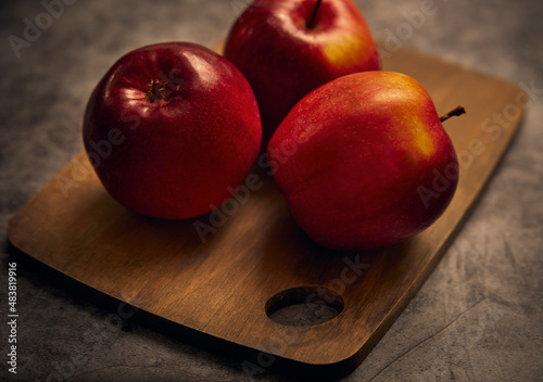 Apples board. Apples are on a cutting board  with a dark background. photo