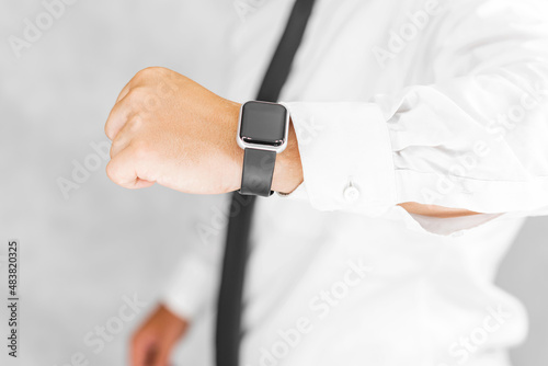 Close-up, smart watch on the hand of a business man. On a light background.