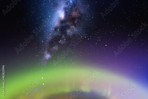 Night starry sky. Milky Way and polar lights. Green aurora borealis