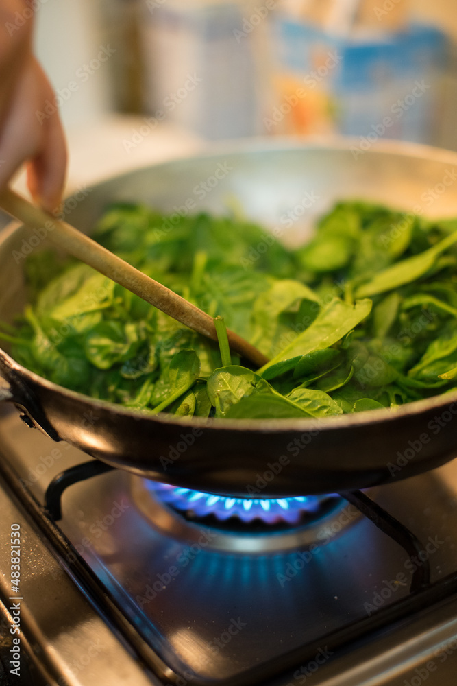 Spinach in a pot with lit fire