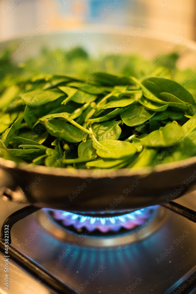 Spinach in a pot with lit fire