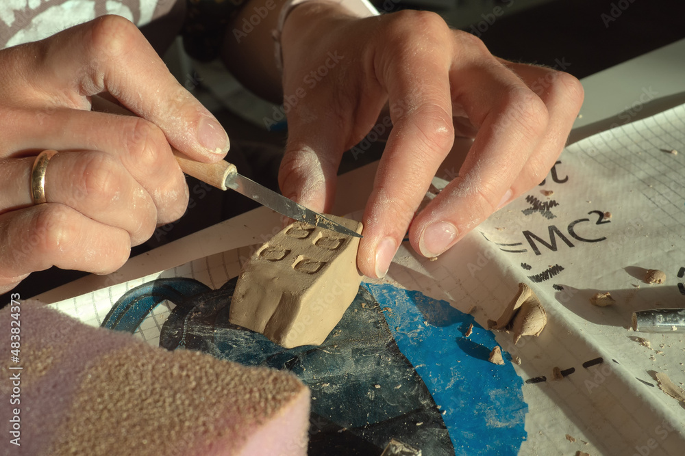 Fototapeta premium Production of clay products at the master class on ceramics in the form of a house. 