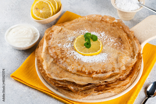 Pancakes with lemon and sugar. Traditional for Shrove Tuesday. Pancake day. Pancakes with lemon juice and powdered sugar. Russian Maslenitsa. Sweet crepes. shrovetide holiday.
